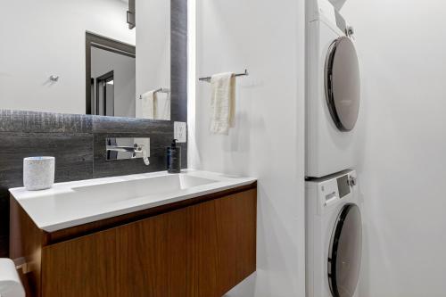 a bathroom with a sink and a refrigerator at Elegant Beachfront Penthouse | Casa Del Mar Delfin in San José del Cabo