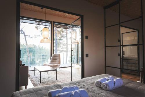 a bedroom with a bed and a large glass window at Stay North - Kajastus in Salo
