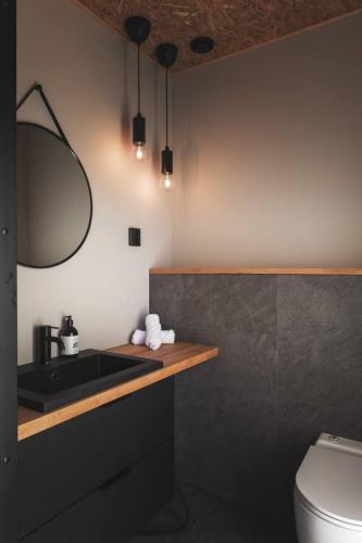 a bathroom with a sink and a toilet at Stay North - Kajastus in Salo