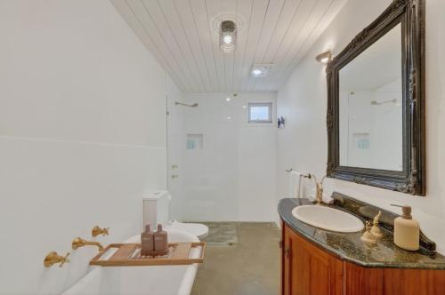 a bathroom with a sink and a mirror at Forty at Yellow Doors in Goolwa South