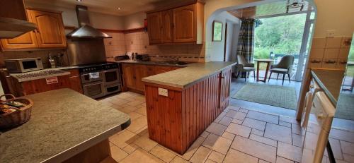 a kitchen with wooden cabinets and a counter top at Hawthorn in Glencoe