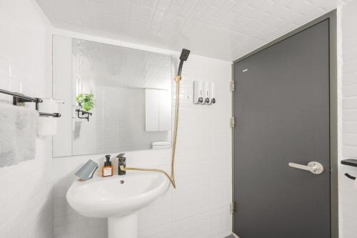 a white bathroom with a sink and a shower at Yoonsul Gwangalli 3beds for 4guests in Suyŏng