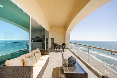 a living room with a couch and a view of the ocean at Mar y Sol 16th floor Condo in Rosarito