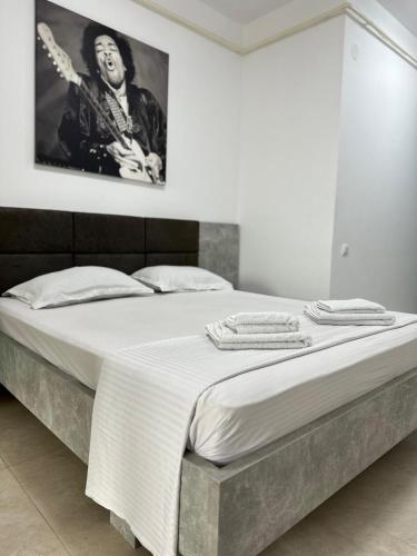 a bedroom with a large bed with a picture on the wall at Travel Studio in Iaşi