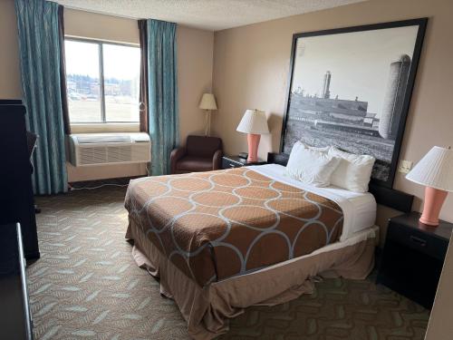 a hotel room with a large bed and a window at Dodgeville inn & suites in Dodgeville