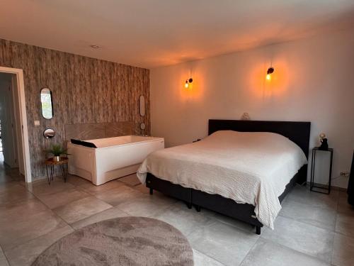 a bedroom with a bed and a bath tub at La Bouverie in Profondeville