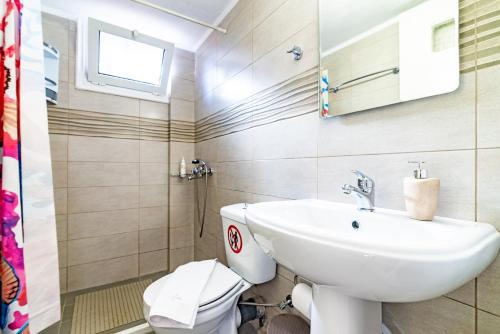 a bathroom with a sink and a toilet at Irene Studio in Amoudara Herakliou