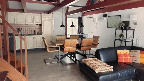 a living room with a table and a couch at Vakantiehuis Toermalijn in Simpelveld