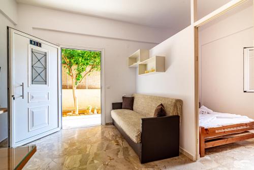 a room with a couch and a bed and a door at Irene Studio in Amoudara Herakliou