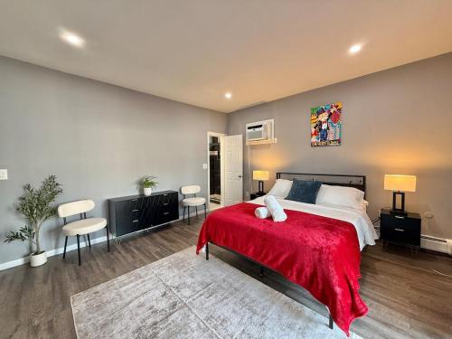 a bedroom with a large bed with a red blanket at Modern apartment close to NYC in North Bergen