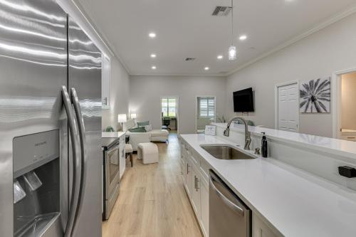 a kitchen with white appliances and a living room at Pool Access + Course View: Golf Getaway in Sebring in Sebring