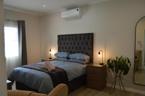 a bedroom with a large bed with blue pillows at Logans Place in Oakdale