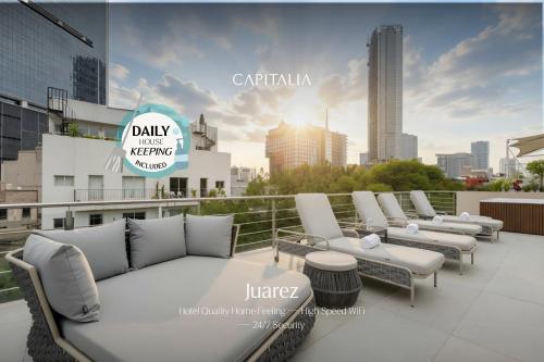 a row of white chairs and tables on a roof at Capitalia Juarez in Mexico City