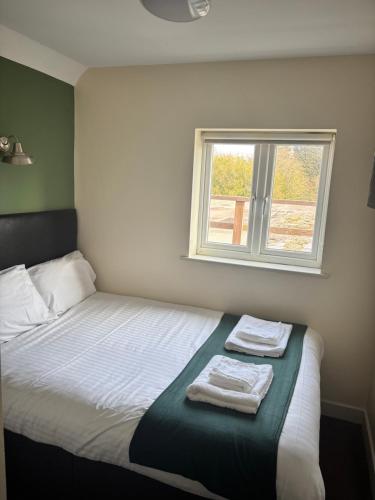 a bedroom with a bed with two towels on it at Liberal House Tamworth in Tamworth