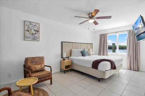 a bedroom with a bed and a chair and a window at Coastal Sunset in Hollywood