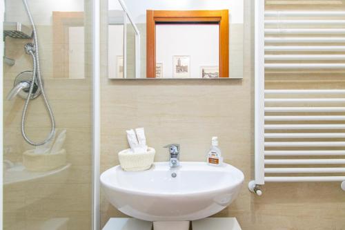 a bathroom with a sink and a shower at ANTONELLI Apartment L'AQUILA in LʼAquila