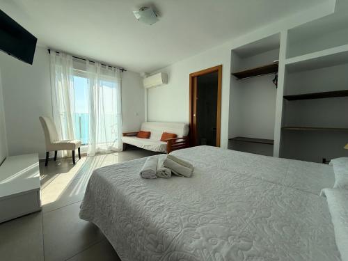 a bedroom with a bed with two towels on it at Living one Bed and Breakfast in Peniscola