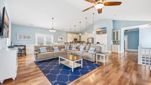 a living room with a couch and a table at The Palm Luxury Beach House w Pool and Game Room in Myrtle Beach