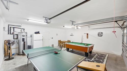 a room with a ping pong table in it at The Palm Luxury Beach House w Pool and Game Room in Myrtle Beach