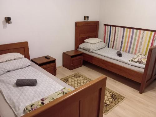 a room with two beds and two rugs at Sprencz Családi Major in Sátoraljaújhely
