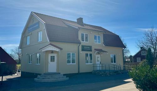a large white house with a gambrel roof at SteneBo in Stenestad