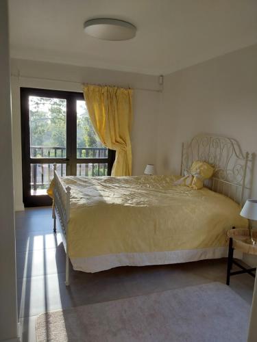 a bedroom with a large bed and a window at Sunset View in Somerset West