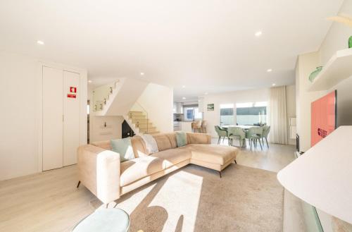 a living room with a couch and a table at GuestReady - Aroeira Pool Villa in Setúbal
