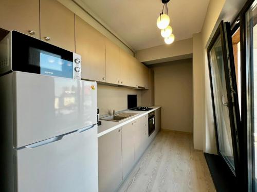 a kitchen with a white refrigerator and a sink at Astryn Aparthotel 9 SELF CHECK-IN #Otopeni #Airport #Therme #Bucharest in Otopeni