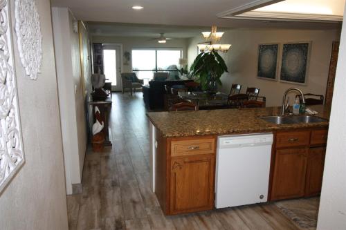 a kitchen and living room with a sink and a dishwasher at 12th Floor Penthouse Beachfront, Large Balcony, Amazing Views, 3 Pools, Tennis in South Padre Island