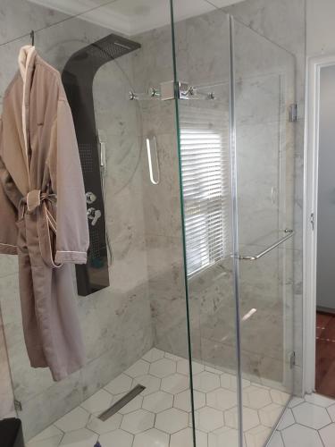 a bathroom with a shower with a glass door at Sunset View in Somerset West