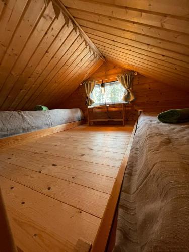 a attic room with two beds and a window at Schwedentraum in Östrahult
