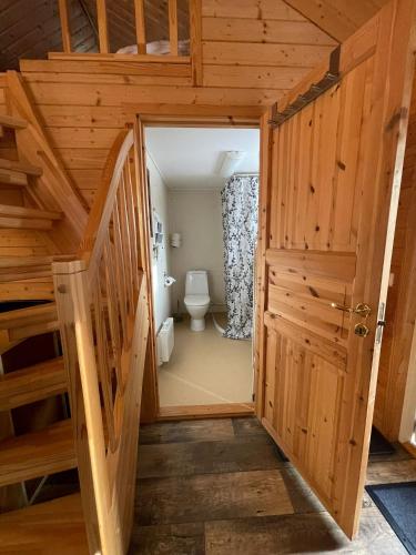 a staircase leading to a bathroom with a toilet at Schwedentraum in Östrahult