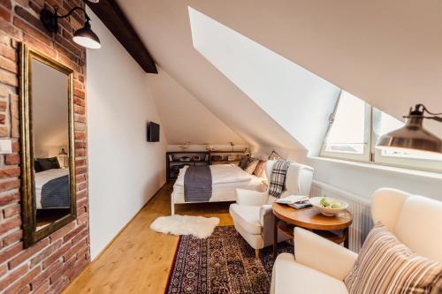 a loft conversion with a bedroom and a bed at Pension Zwicker in Prešov