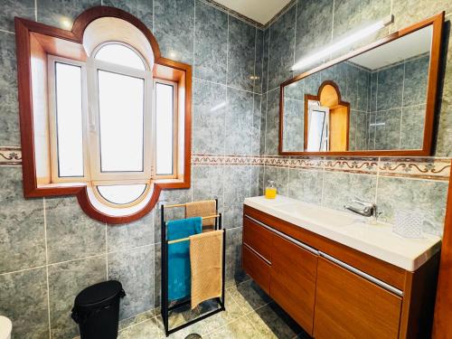 a bathroom with a sink and a mirror at Cantinho da Paz in Marinhas