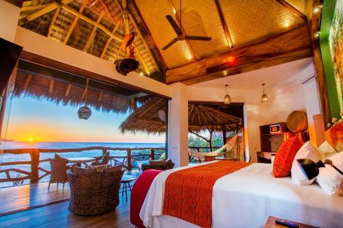 a bedroom with a bed and a view of the ocean at Villa Lala Boutique Hotel Adults Only in Puerto Vallarta