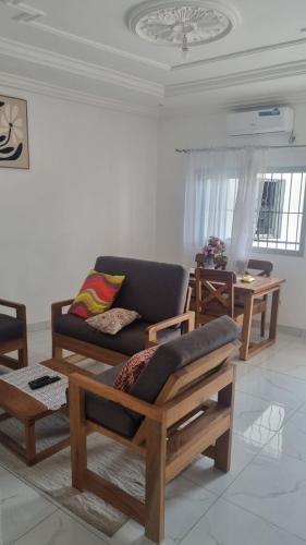 a living room with a couch and a table at RESIDENCE Tanta in Douala