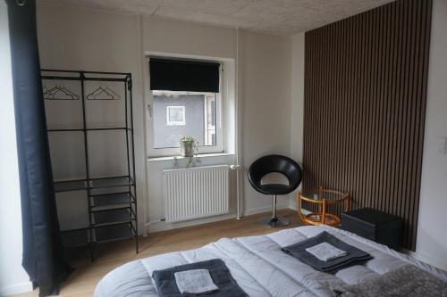 a bedroom with a bed and a window at Værelse tæt på strand og by in Hirtshals