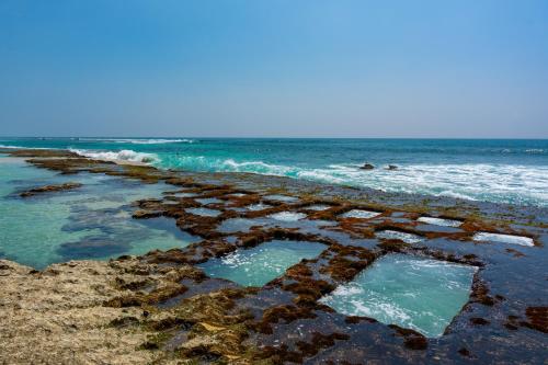 a beach with two pools of water on the shore at Talpe Paradise in Galle