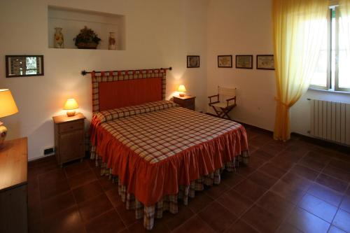 a bedroom with a bed and two tables and two lamps at Le Matine di San Teodoro in Stazione di Metaponto