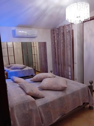 a bedroom with two beds and a chandelier at Aghi&Salsedine in Anzio