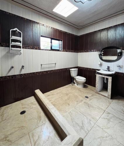 a bathroom with a toilet and a sink at La prieta linda in Tamasopo