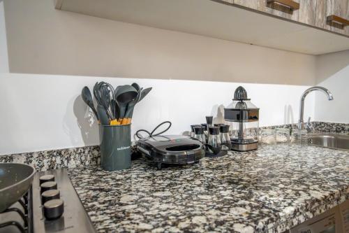 a kitchen with a counter top with utensils on it at JASMINe in Marrakesh