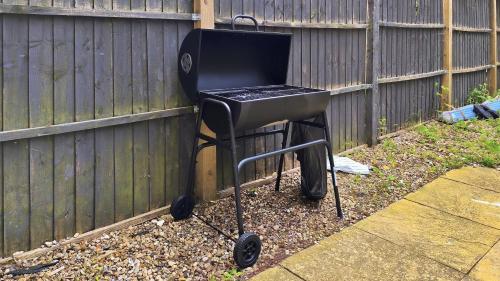 a barbecue grill sitting next to a fence at Riverview, studio style room near station R3 in London