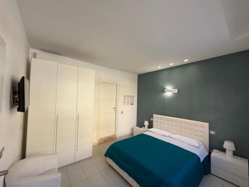 a bedroom with a bed with a blue blanket at The Smerald in Alghero