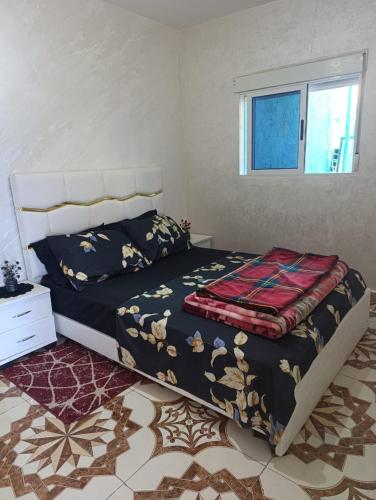 a bedroom with a bed and a window at Casa Yessef Akchour in Akchour