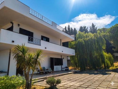 a large white house with a patio and trees at Villa Vit The Adriatic Experience in Vasto