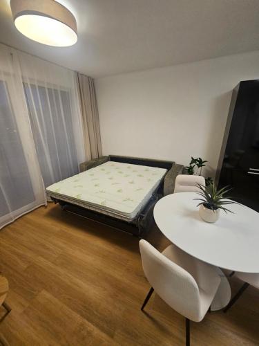 a room with a bed and a table and chairs at 365 apartmány AUPARK in Piešťany