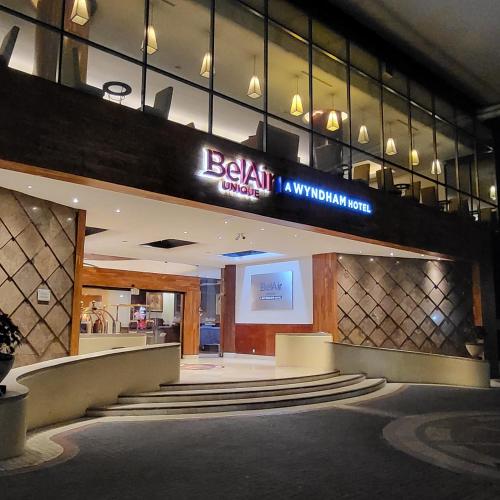 a lobby of a hotel with a sign that reads beijing airport at BelAir Unique a Wyndham Hotel in Mexico City