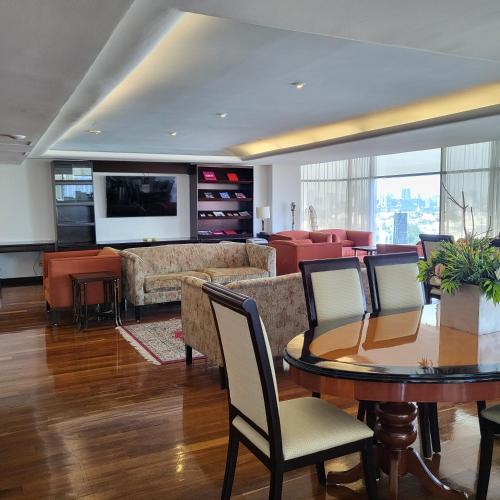a living room with a table and a couch at BelAir Unique a Wyndham Hotel in Mexico City