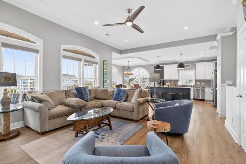 a living room with a couch and a table at 5 BR Poolside Paradise Just Steps from the Beach in Ocean Isle Beach